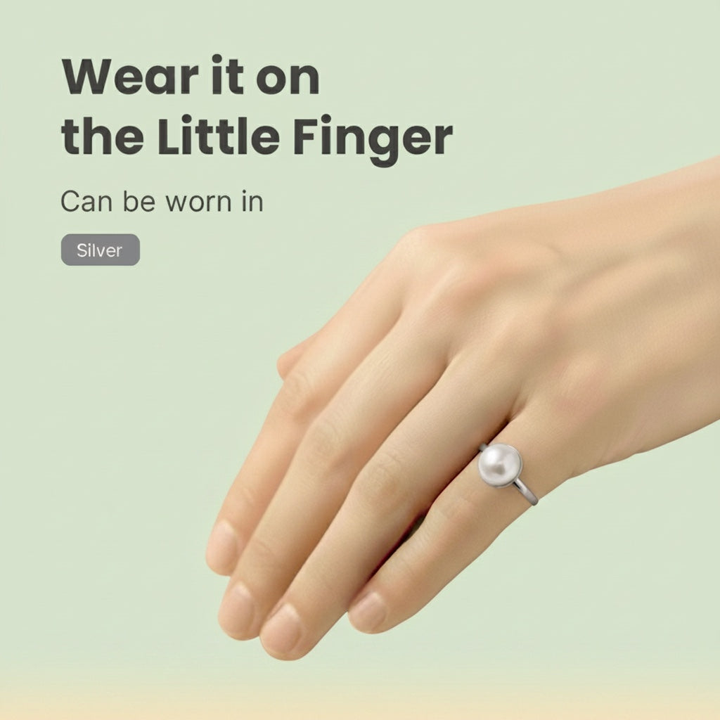 VASTUKOSHA pearl ring worn on the little finger, featuring a smooth white gemstone set in a polished silver band.