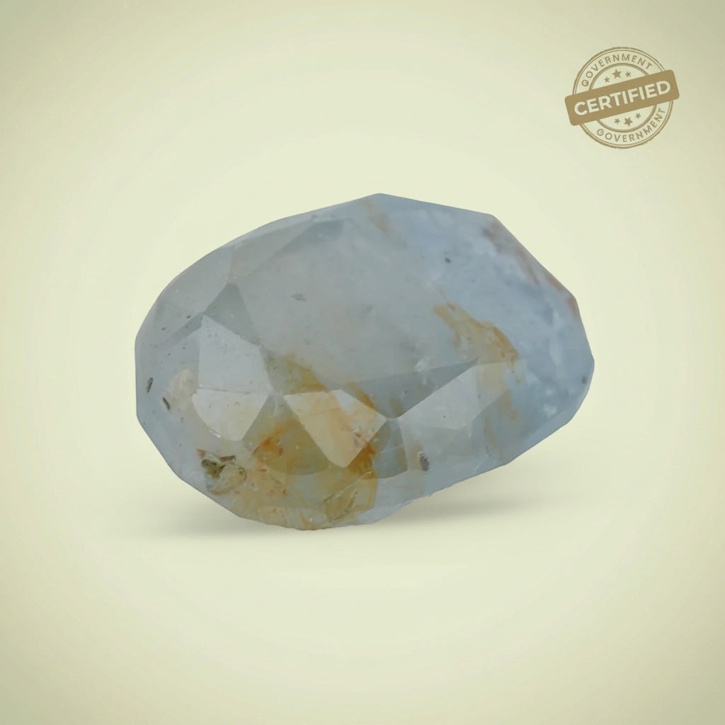 VASTUKOSHA Peetambari Neelam gemstone with a pale blue and golden-yellow hue, featuring a faceted cut.