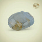 VASTUKOSHA Peetambari Neelam gemstone with a pale blue and golden-yellow hue, featuring a faceted cut.