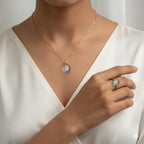 VASTUKOSHA Peetambari Neelam gemstone set in a gold necklace and ring worn by a woman in a white blouse.
