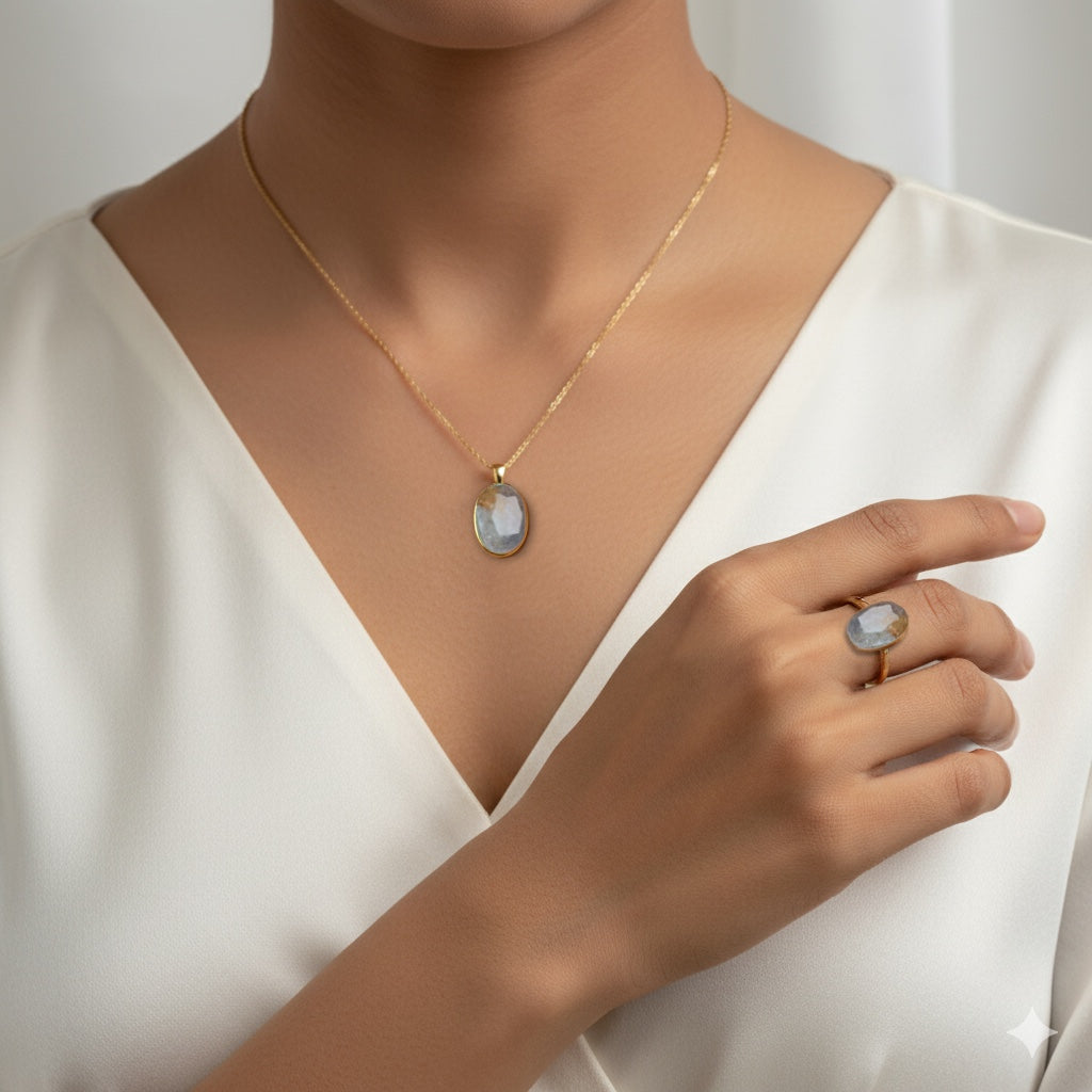 VASTUKOSHA Peetambari Neelam gemstone set in a gold necklace and ring worn by a woman in a white blouse.