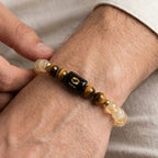 VASTUKOSHA Pisces zodiac bracelet featuring citrine and tiger eye beads with a central black Pisces symbol charm.