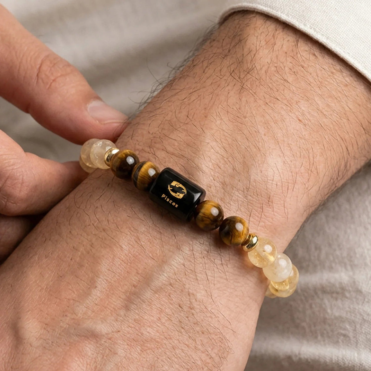 VASTUKOSHA Pisces zodiac bracelet featuring citrine and tiger eye beads with a central black Pisces symbol charm.