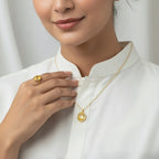VASTUKOSHA Pukhraj yellow sapphire pendant and matching ring set worn by a woman in a white shirt