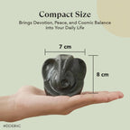 VASTUKOSHA Pyrite Ganesha idol held in a hand, showing its compact 7cm by 8cm size for home or office decor.