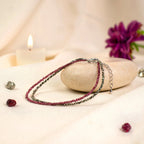 VASTUKOSHA double-layered anklet featuring natural pyrite and garnet beads with an adjustable chain and hook closure.