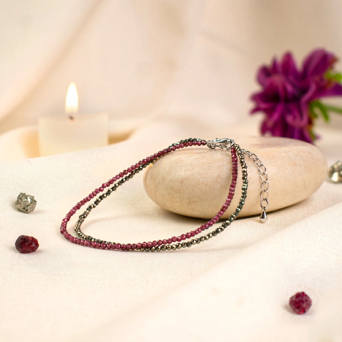VASTUKOSHA double-layered anklet featuring natural pyrite and garnet beads with an adjustable chain and hook closure.