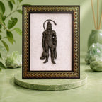 VASTUKOSHA Siddh Pyrite Hanuman Ji idol mounted on a white Selenite frame with an ornate gold and brown border