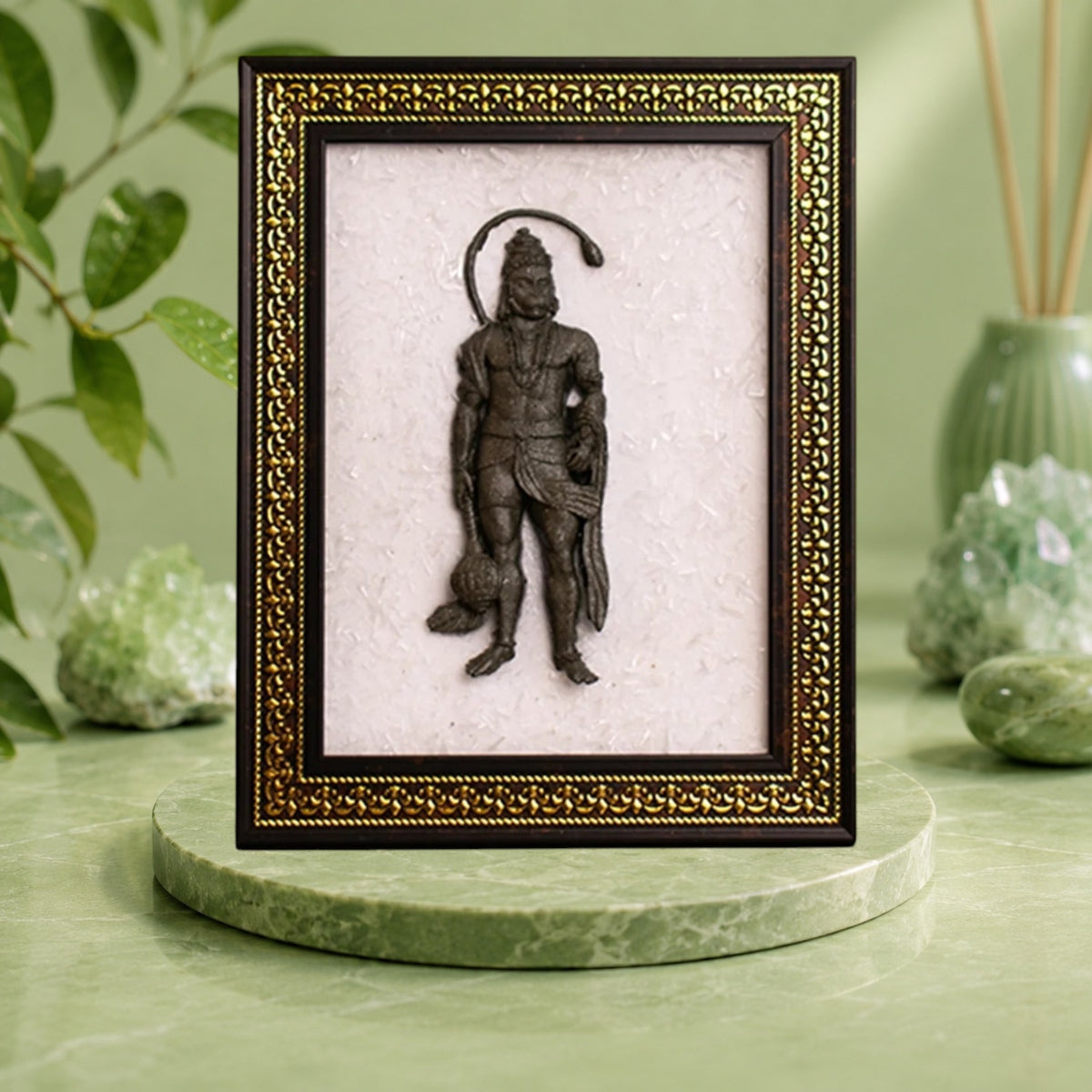 VASTUKOSHA Siddh Pyrite Hanuman Ji idol mounted on a white Selenite frame with an ornate gold and brown border