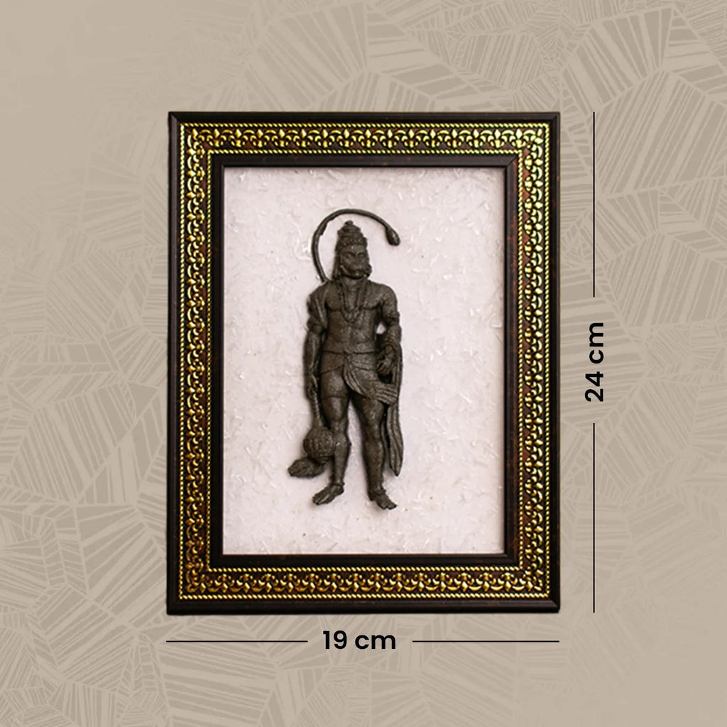 VASTUKOSHA Pyrite Hanuman Ji idol mounted on a white Selenite crystal frame with an ornate gold and dark wood border.