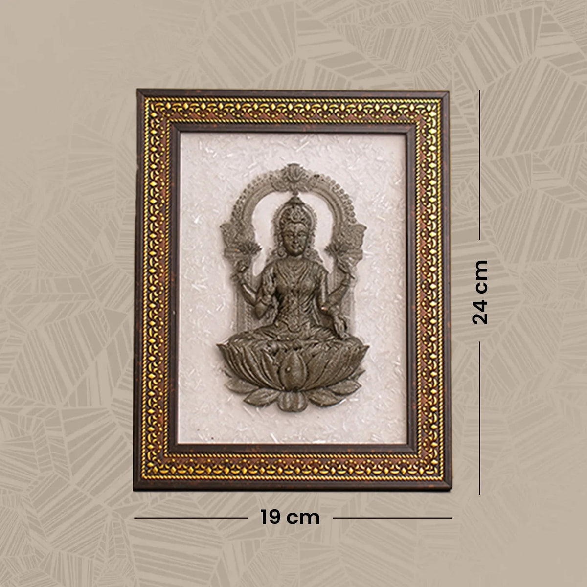 VASTUKOSHA Lakshmi Ji idol crafted from pyrite, mounted on a white selenite plate within a decorative brown frame.