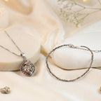 VASTUKOSHA Princess Combo featuring a raw capped pyrite pendant and a delicate pyrite bead anklet on a silk background.