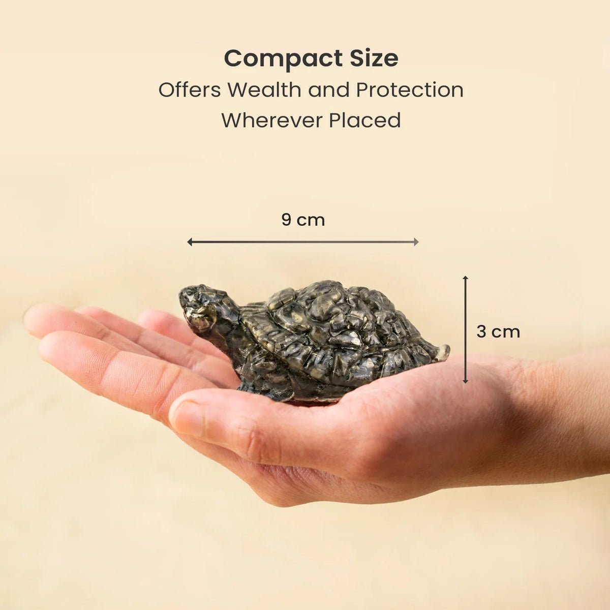 VASTUKOSHA natural pyrite tortoise figurine held in a hand, showing its compact size and metallic textured shell.