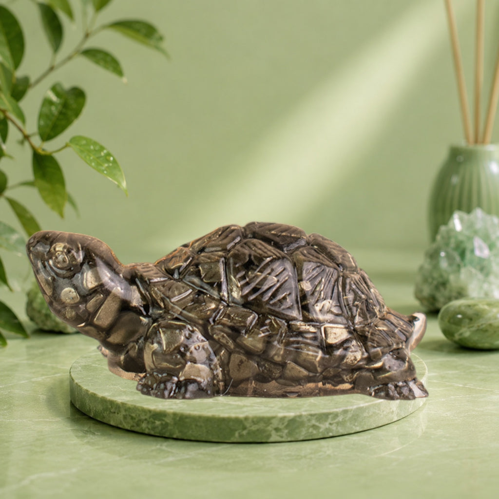 VASTUKOSHA Maha Ashtlakshmi Siddh Pyrite Tortoise on a white marble base with a Goddess Lakshmi statue in the background