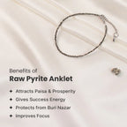 VASTUKOSHA raw pyrite anklet with metallic grey beads on a white silk background, highlighting prosperity benefits.
