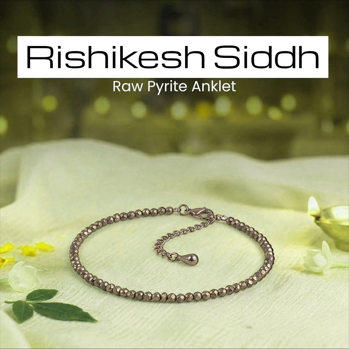 VASTUKOSHA Rishikesh Siddh raw pyrite anklet with metallic beads on a white cloth with a diya and flower petals