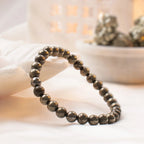 VASTUKOSHA raw pyrite beaded bracelet with metallic 6mm stones on a soft white fabric background