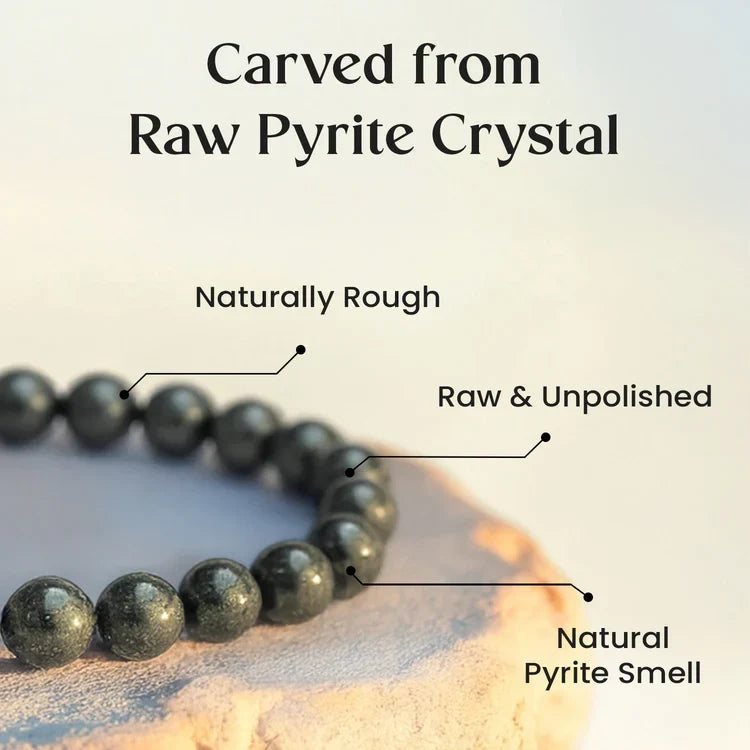 VASTUKOSHA raw pyrite crystal bracelet with rough, unpolished metallic beads on a textured surface.