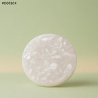 VASTUKOSHA raw white Moroccan selenite crystal plate for meditation and crystal cleansing on a soft green background