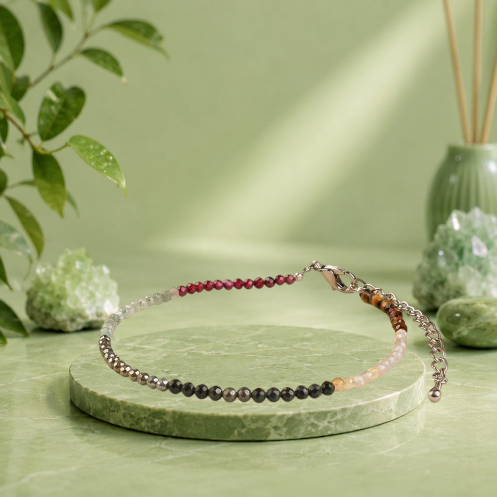 VASTUKOSHA Rinmukteshwar Siddh Dhan Yog Anklet featuring multi-colored healing crystals on a soft fabric background.