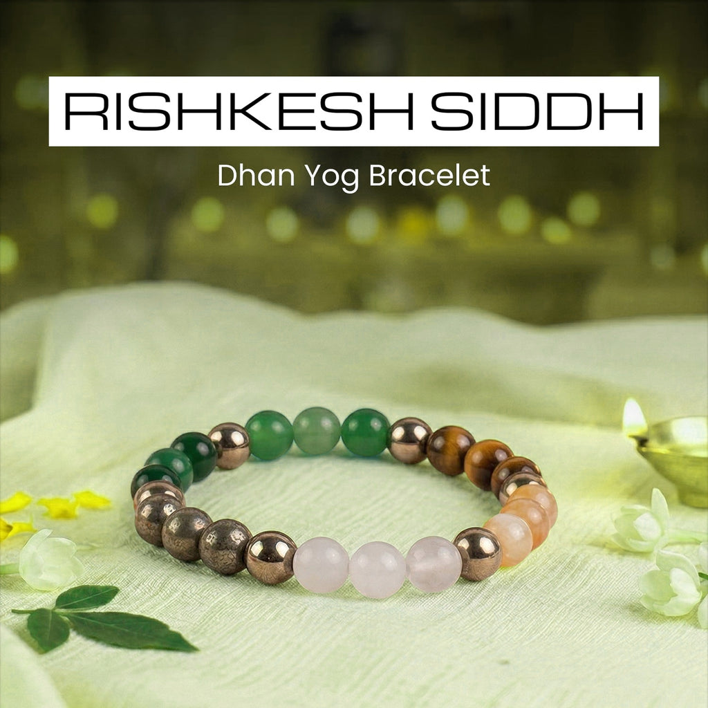 VASTUKOSHA Rishikesh Siddh Dhan Yog crystal bracelet featuring green, brown, and pink beads on a light fabric surface.