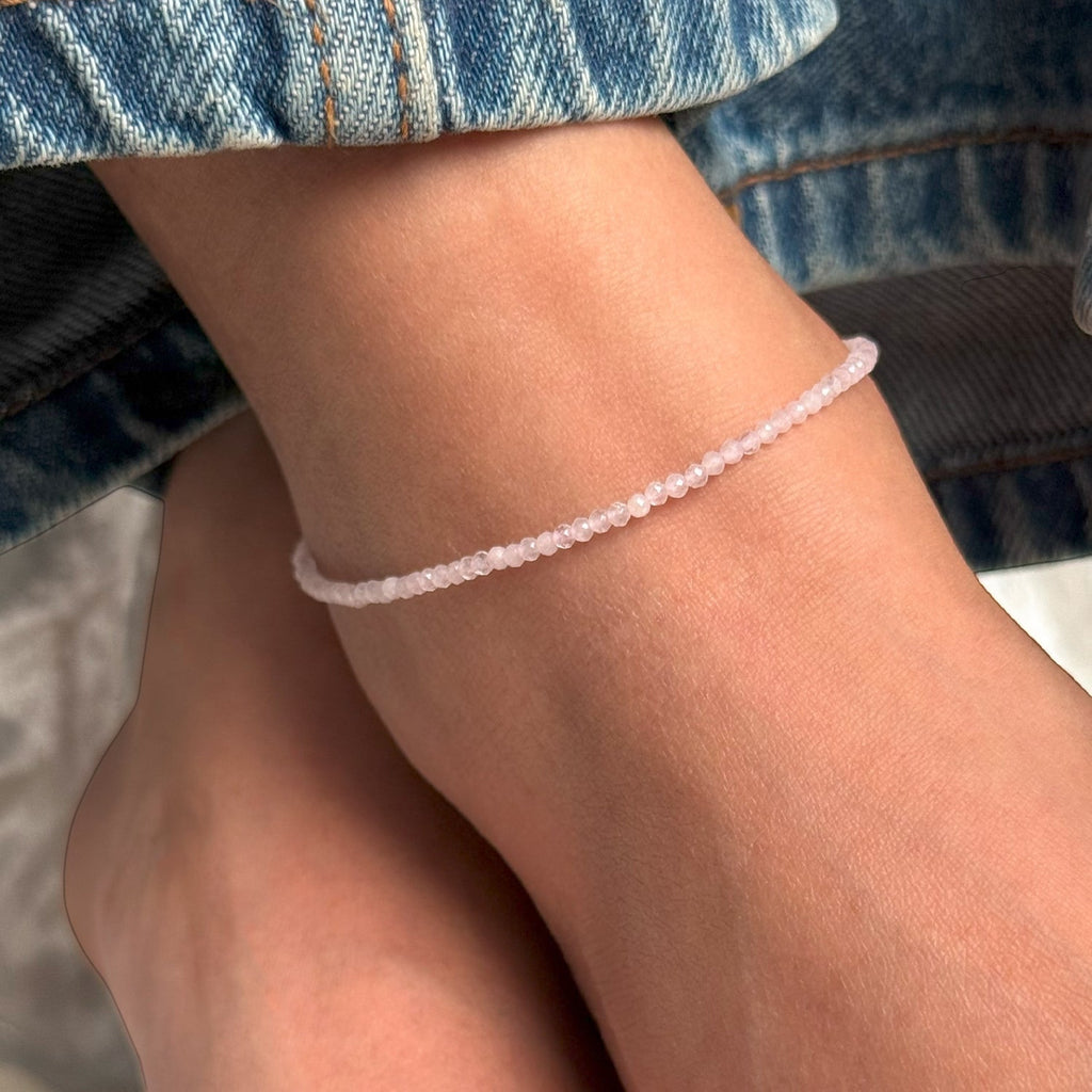 VASTUKOSHA delicate natural rose quartz anklet worn on an ankle, featuring small faceted pink stone beads.