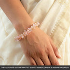 VASTUKOSHA rose quartz chip bracelet worn on a woman's wrist against a cream-colored fabric background