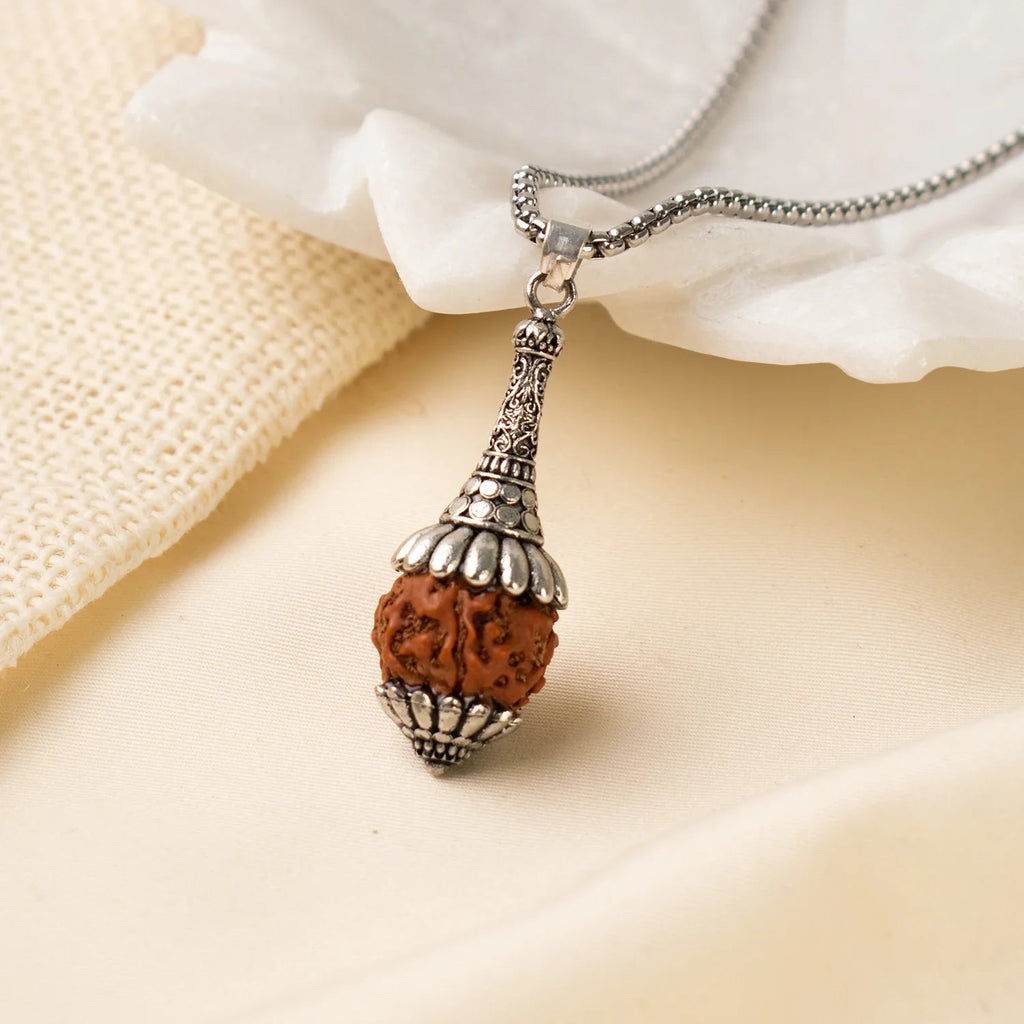 VASTUKOSHA Rudraksha Hanuman Gada pendant featuring a 5 Mukhi Rudraksha bead in an ornate silver-toned metal setting.