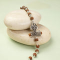 VASTUKOSHA Om Trinetra Trishul Damru Rudraksha bracelet with silver-tone Shiva symbols on smooth white stones.