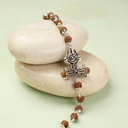 VASTUKOSHA Om Trinetra Trishul Damru Rudraksha bracelet with silver-tone Shiva symbols on smooth white stones.