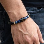 VASTUKOSHA Sagittarius zodiac bracelet featuring black obsidian and blue lapis lazuli beads on a man's wrist