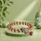 VASTUKOSHA Rishikesh Siddh Shiv Rudraksha Mala with silver Adiyogi pendant on a cloth with flower petals