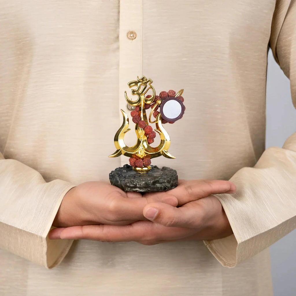 VASTUKOSHA Shiva Shakti Trishul murti with Om, Damru, and Rudraksha beads held in hands, gold finish devotional decor.