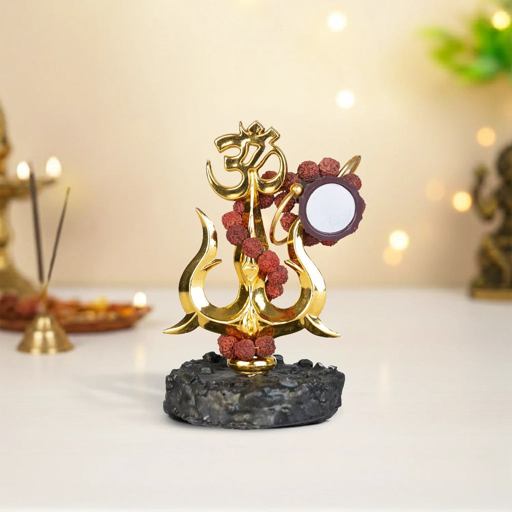 VASTUKOSHA Shiva Shakti Trishul murti with Om symbol, Damru, and Rudraksha beads on a textured black base for home temple.