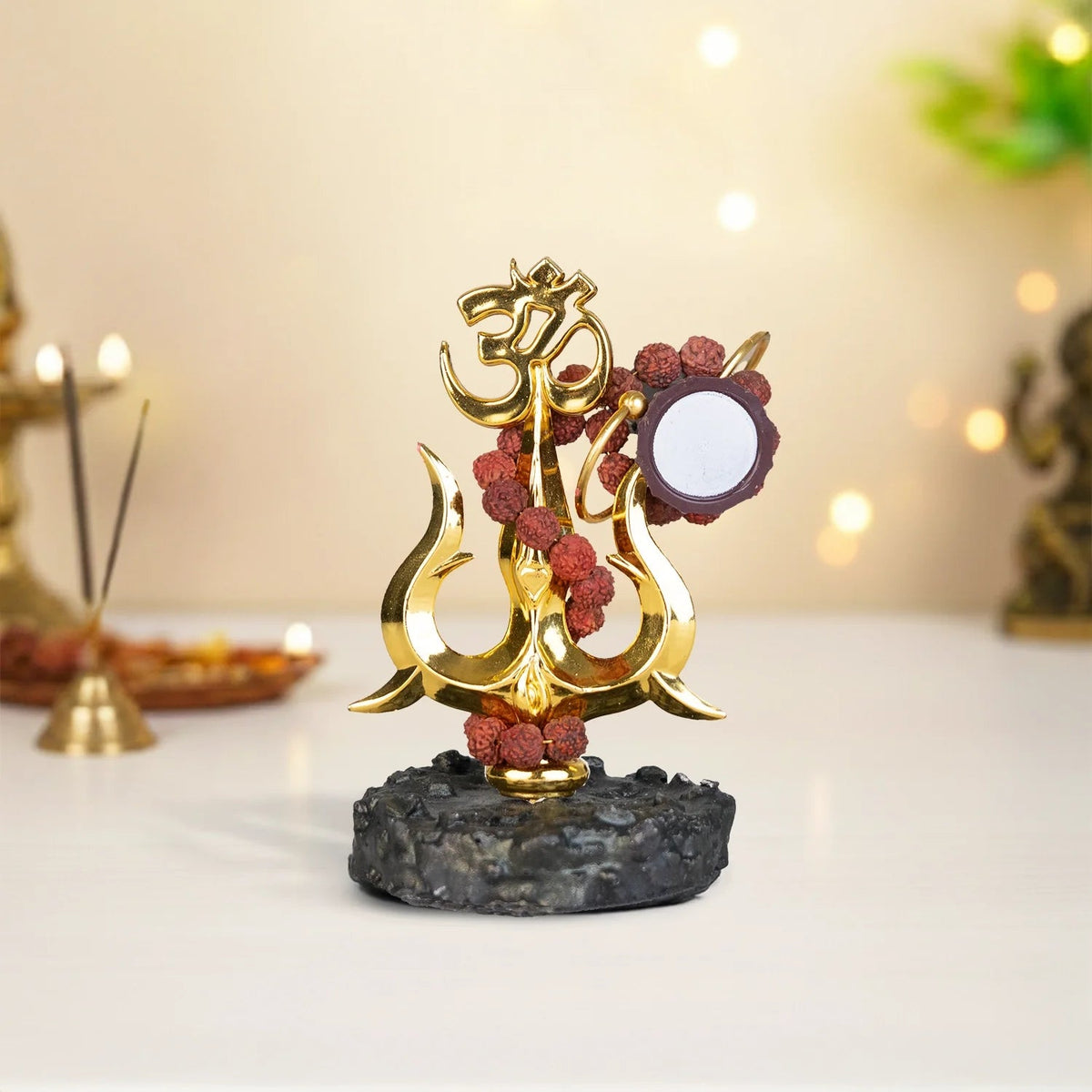 VASTUKOSHA Shiva Shakti Trishul murti with Om symbol, Damru, and Rudraksha beads on a textured black base for home temple.