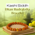 VASTUKOSHA Siddh Dhan Rudraksha bracelet with gold-toned beads on a cloth, set against a spiritual temple background.