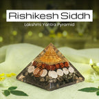 VASTUKOSHA Rishikesh Siddh Lakshmi Yantra Pyramid with gold-tone top, rudraksha beads, and shells on a white cloth.