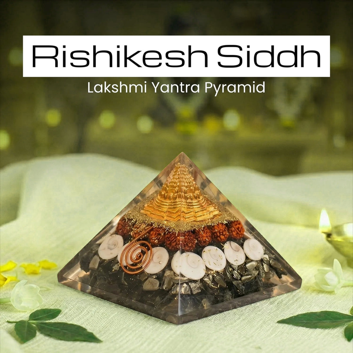 VASTUKOSHA Rishikesh Siddh Lakshmi Yantra Pyramid with gold-tone top, rudraksha beads, and shells on a white cloth.