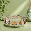 VASTUKOSHA Rishikesh Siddh Metal Dhan Yog silver bracelet featuring six natural crystals on a textured fabric surface.