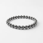 VASTUKOSHA Karz Mukti bracelet made of polished silver hematite beads on a white background