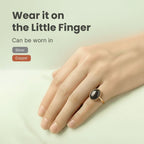 VASTUKOSHA Sulemani Hakik gemstone ring worn on the little finger, featuring a smooth black oval stone in a metal setting
