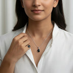 VASTUKOSHA Sulemani Hakik gemstone pendant and matching ring set in silver worn by a woman in a white shirt