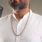 VASTUKOSHA Vishnu Tulsi Mala featuring natural wood beads with silver-plated anti-tarnish caps worn by a man