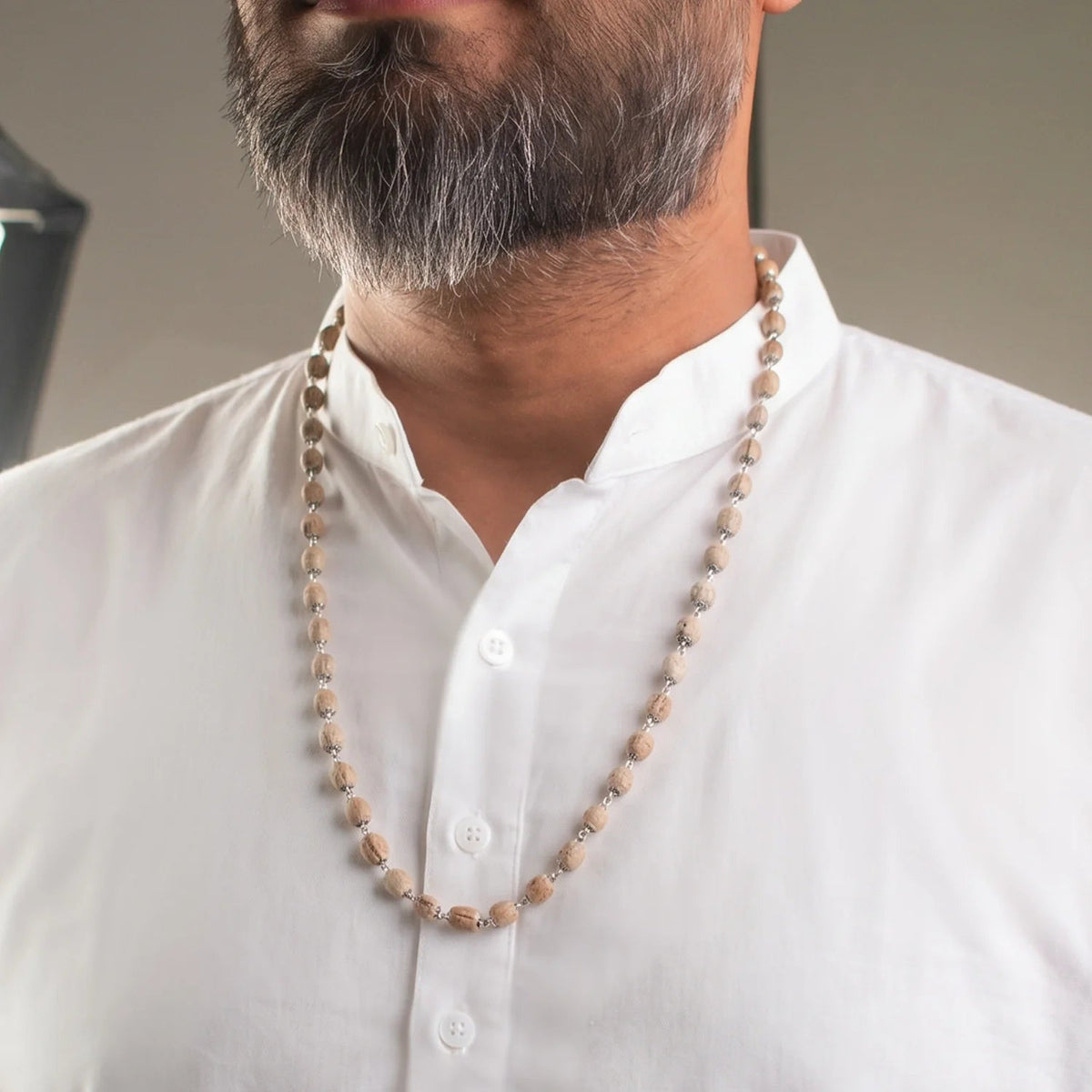 VASTUKOSHA Vishnu Tulsi Mala featuring natural wood beads with silver-plated anti-tarnish caps worn by a man