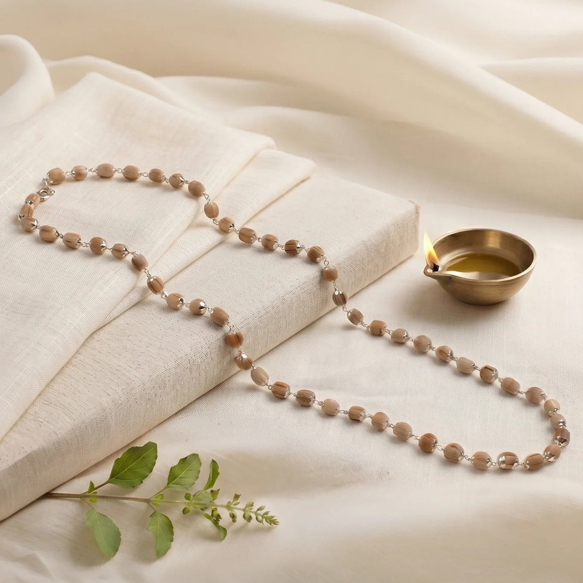 VASTUKOSHA Vishnu Tulsi Mala featuring natural wood beads with silver-plated anti-tarnish caps for spiritual practice.