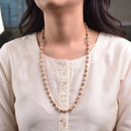VASTUKOSHA Vishnu Tulsi Mala featuring natural wood beads with silver-plated anti-tarnish caps worn by a woman.