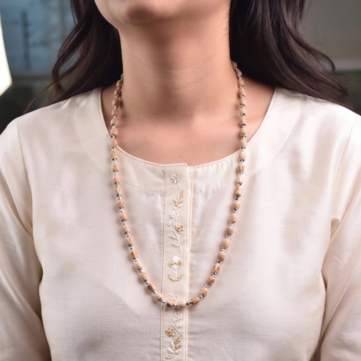 VASTUKOSHA Vishnu Tulsi Mala featuring natural wood beads with silver-plated anti-tarnish caps worn by a woman.