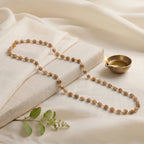 VASTUKOSHA Vishnu Tulsi Mala with natural wood beads and silver-plated anti-tarnish caps on a white fabric background.