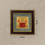 VASTUKOSHA Vyapar Vriddhi Yantra in a dark wood frame with gold accents, featuring sacred symbols for business growth.
