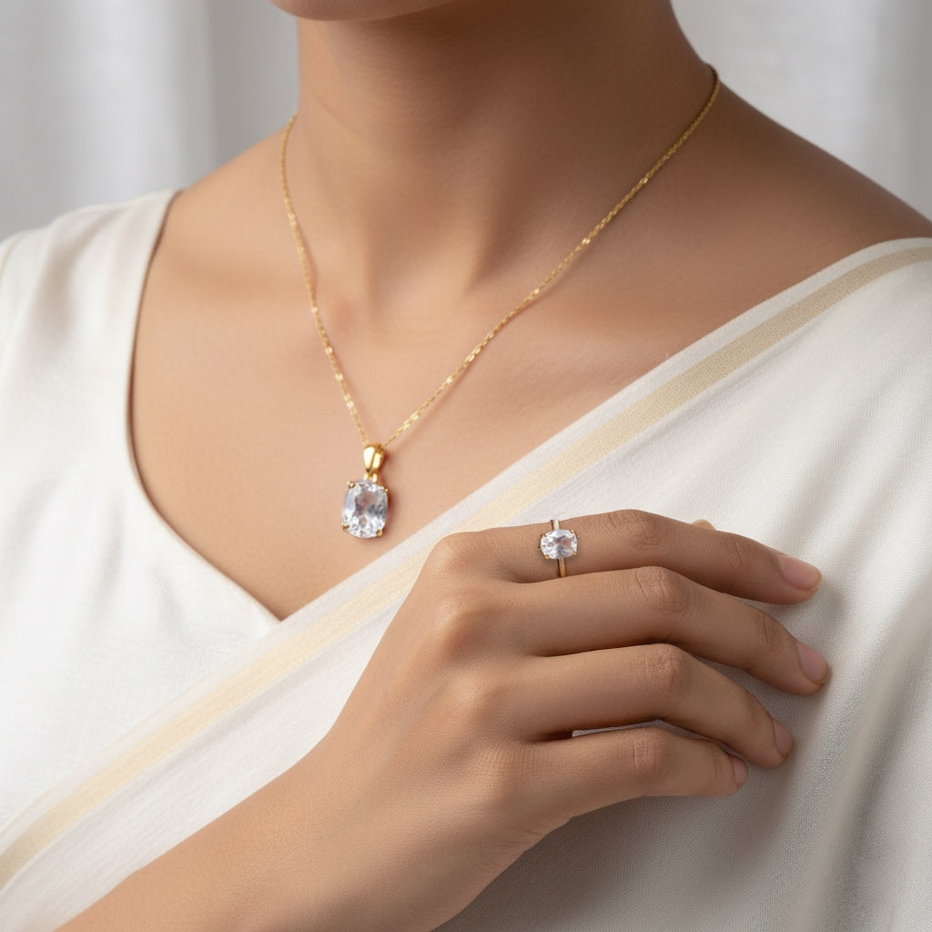 VASTUKOSHA White Pukhraj gemstone pendant and ring set in gold, worn by a woman in a white outfit.